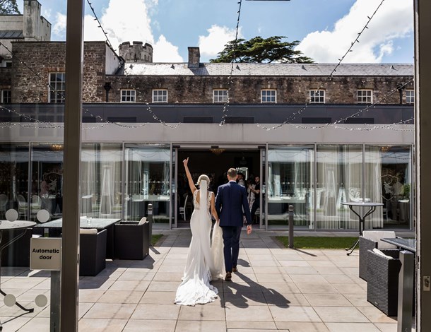 Couple walking into Courtyard Hall