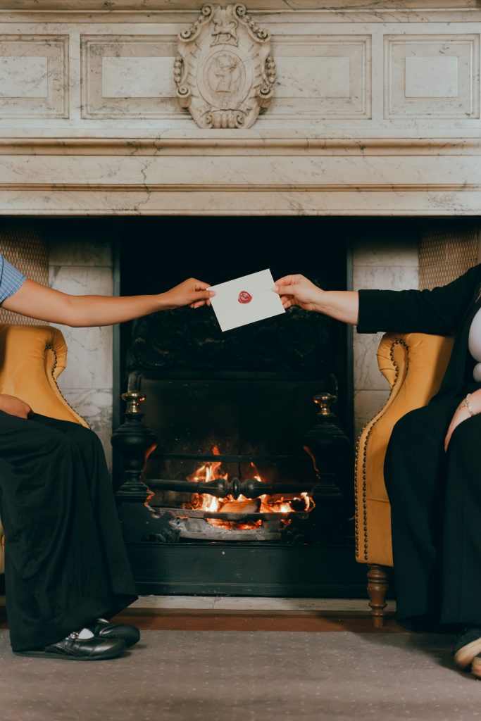 passing envelope in front of fireplace